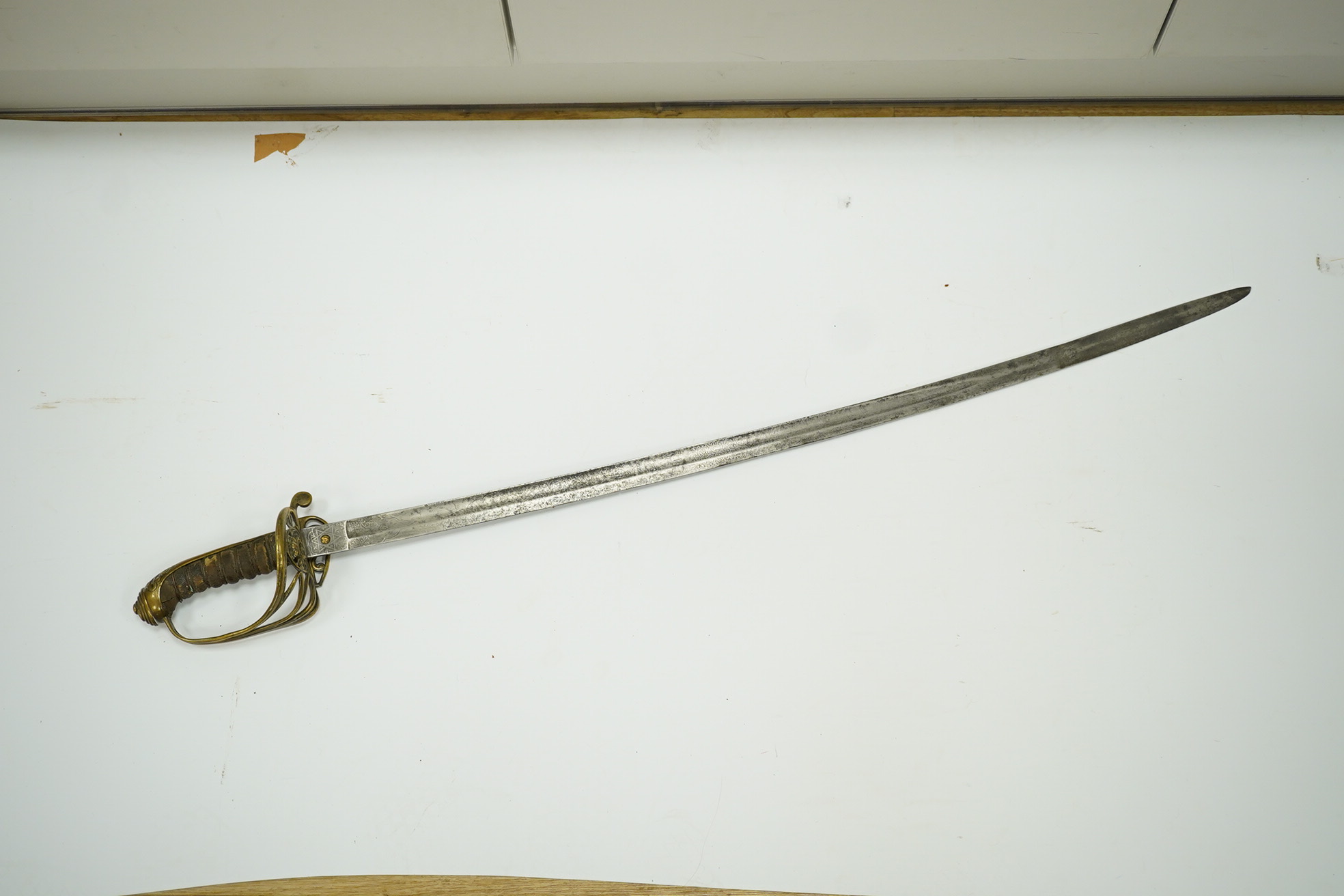 A Victorian 1845 pattern infantry officer’s sword, with regulation blade and brass hilt with folding side guard. Condition - fair, well worn over all.